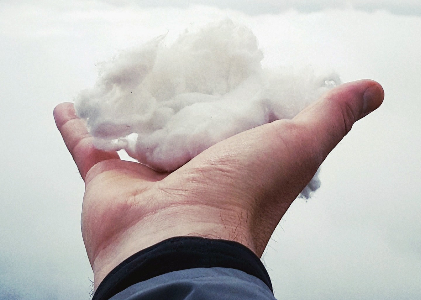 A hand holding a cotton-like cloud representing the 'Public Cloud Platforms Overview' search query.